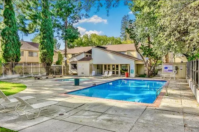 a view of a house with swimming pool and sitting area
