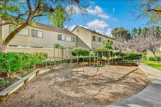a backyard of a house with plants and trees