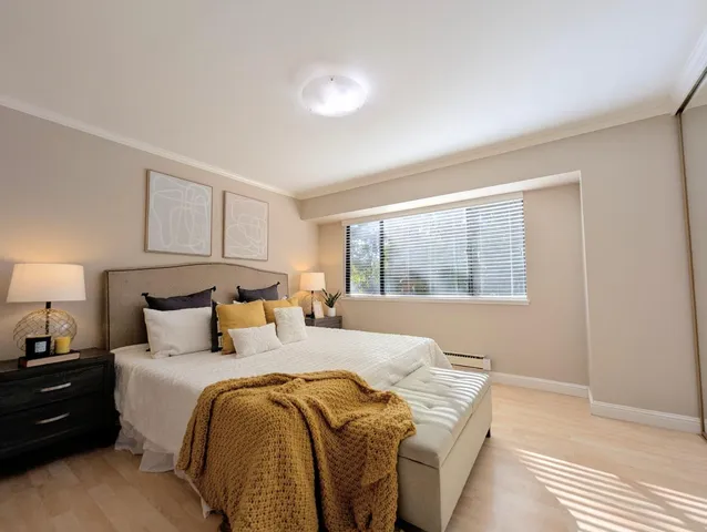 a bedroom with a bed and a large window