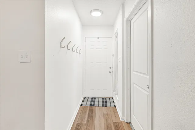 a view of a hallway with wooden floor