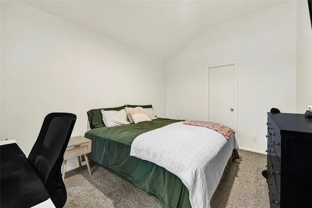 a bedroom with a bed and a chair