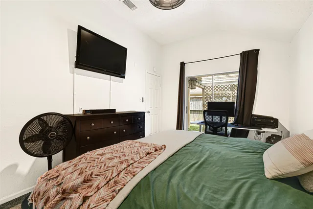 a bedroom with a bed and a flat screen tv