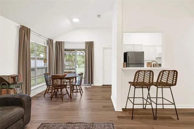 a dining room with furniture a rug and wooden floor