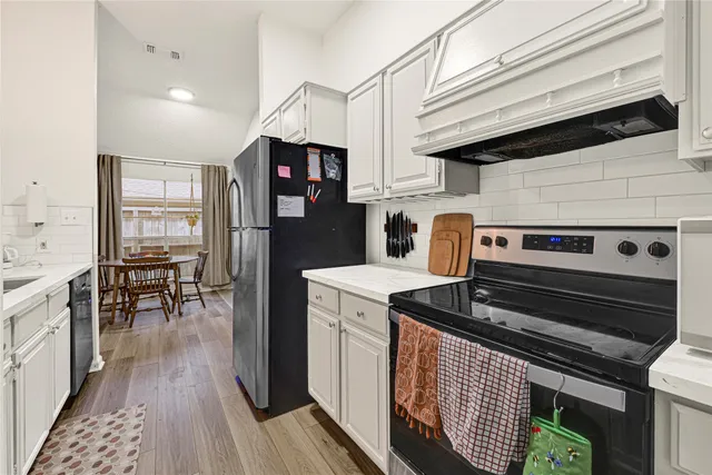 a kitchen with a stove and a refrigerator