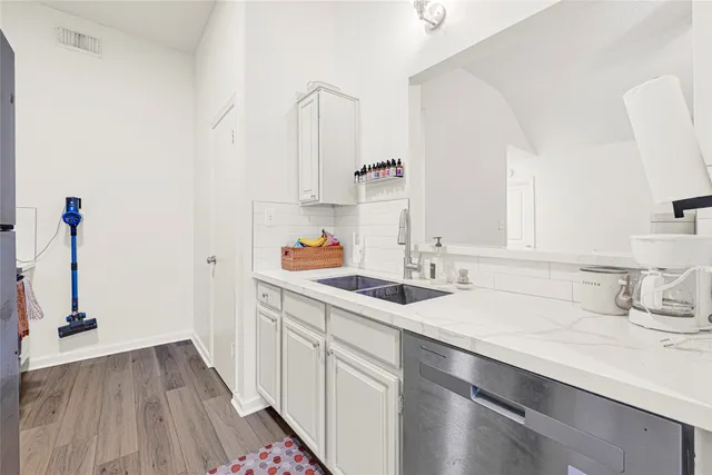 a kitchen with a sink and cabinets
