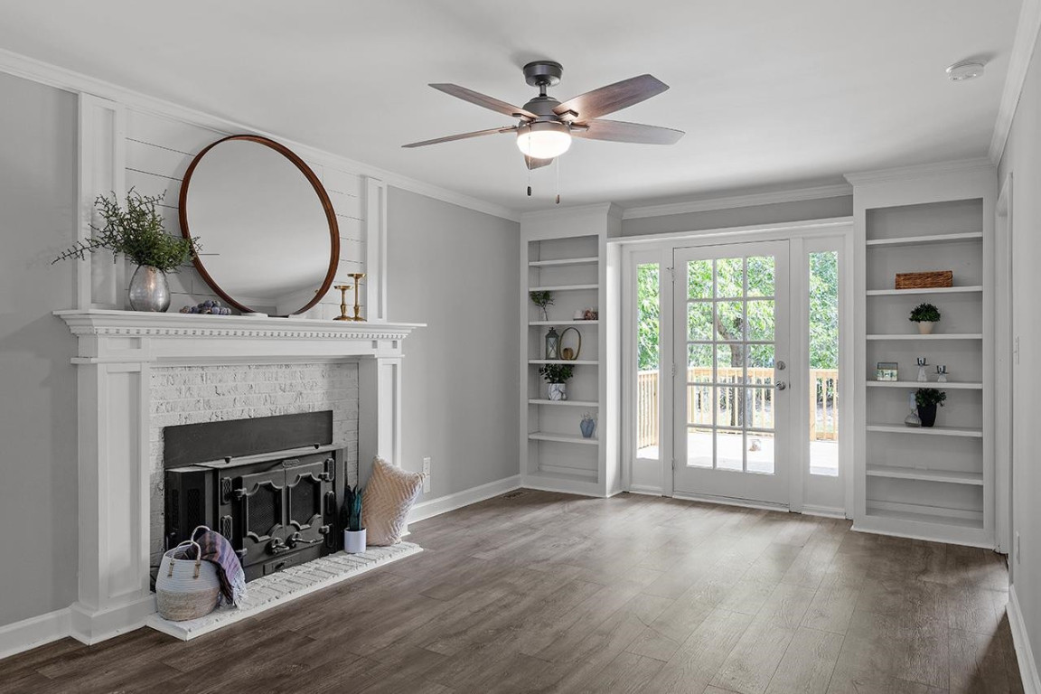 Undisclosed Address Wake Forest, NC 27587 - Photo 2 of 26 a view of an empty room with exposed radiator and fireplace