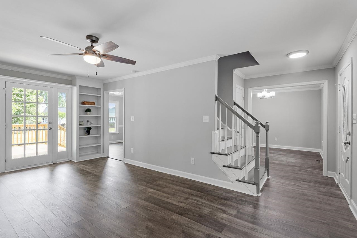 Undisclosed Address Wake Forest, NC 27587 - Photo 3 of 26 a view of an empty room with wooden floor ceiling fan and windows