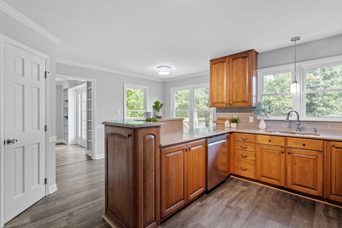Undisclosed Address Wake Forest, NC 27587 - Photo 5 of 26 a kitchen with stainless steel appliances granite countertop wooden floors and sink