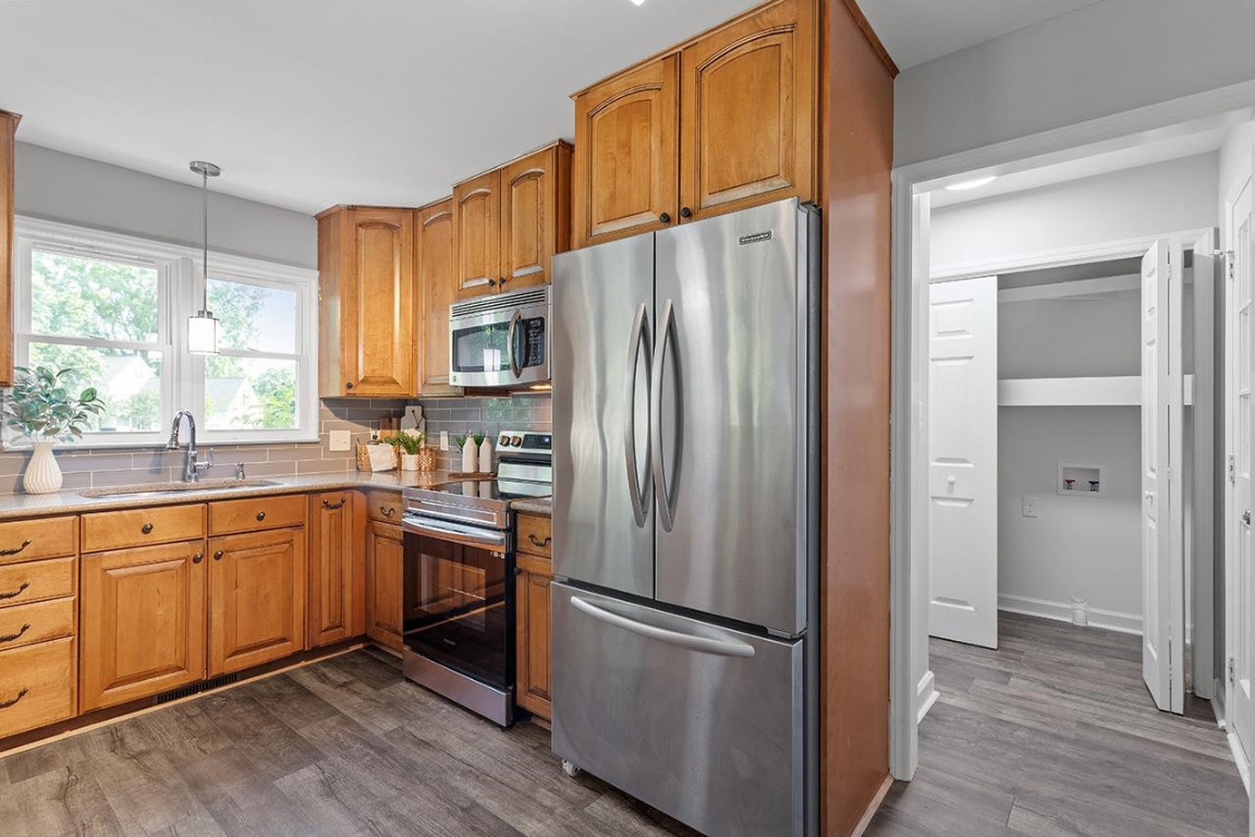Undisclosed Address Wake Forest, NC 27587 - Photo 6 of 26 a kitchen with stainless steel appliances granite countertop a refrigerator sink and cabinets