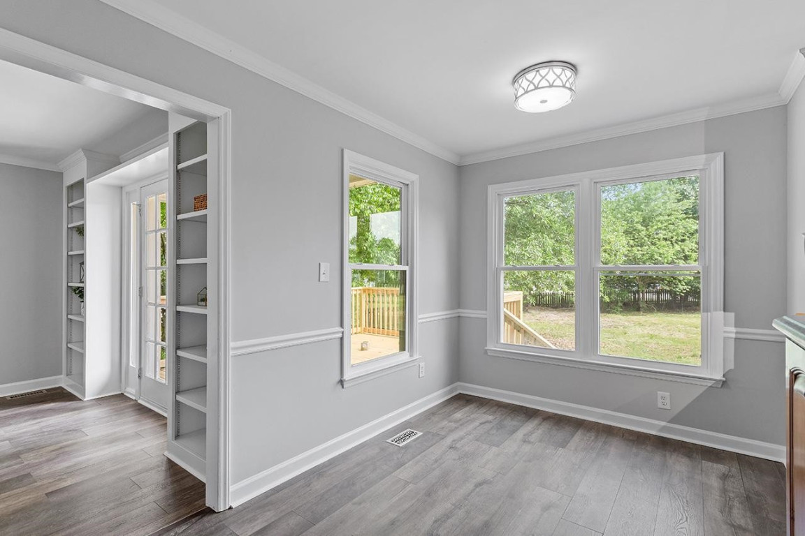 Undisclosed Address Wake Forest, NC 27587 - Photo 9 of 26 an empty room with wooden floor and windows