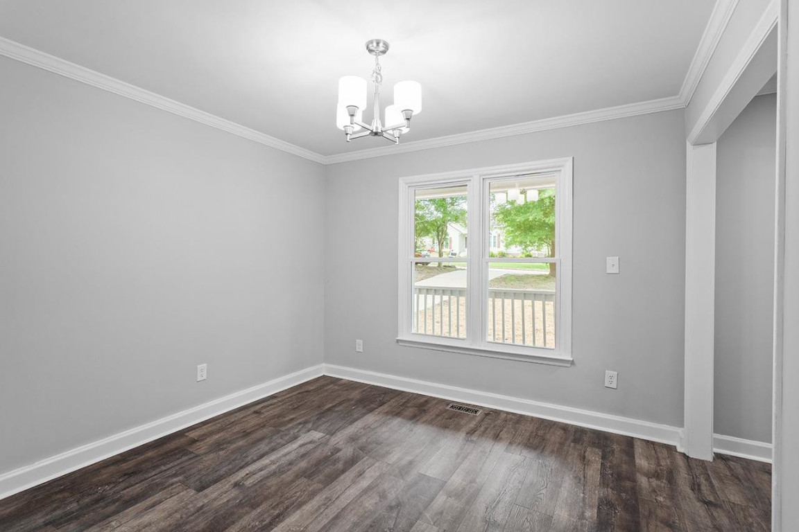 Undisclosed Address Wake Forest, NC 27587 - Photo 10 of 26 a view of an empty room with wooden floor and a window