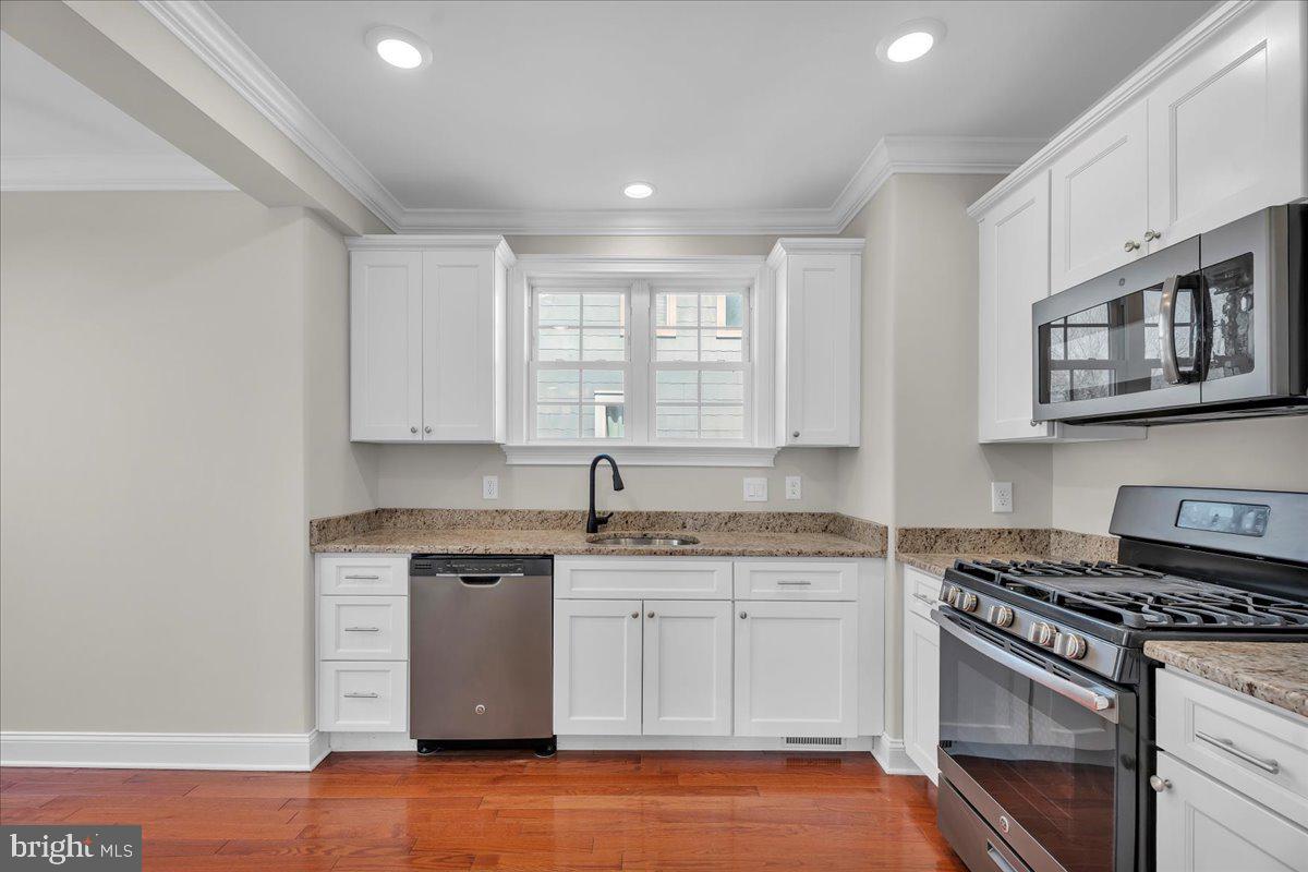 101 Center Avenue Mount Ephraim, NJ 08059 - Photo 11 of 42 a kitchen with stainless steel appliances granite countertop a stove and a sink