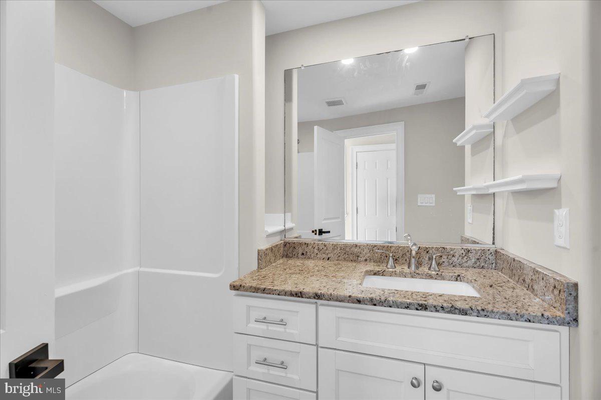 101 Center Avenue Mount Ephraim, NJ 08059 - Photo 16 of 42 a bathroom with a granite countertop sink and a mirror