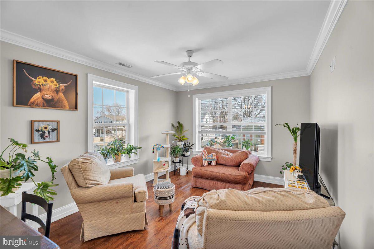 101 Center Avenue Mount Ephraim, NJ 08059 - Photo 23 of 42 a living room with furniture a large window and a flat screen tv