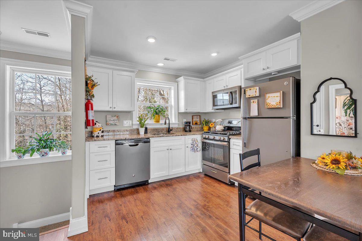 101 Center Avenue Mount Ephraim, NJ 08059 - Photo 26 of 42 a kitchen with stainless steel appliances granite countertop a stove refrigerator sink and window