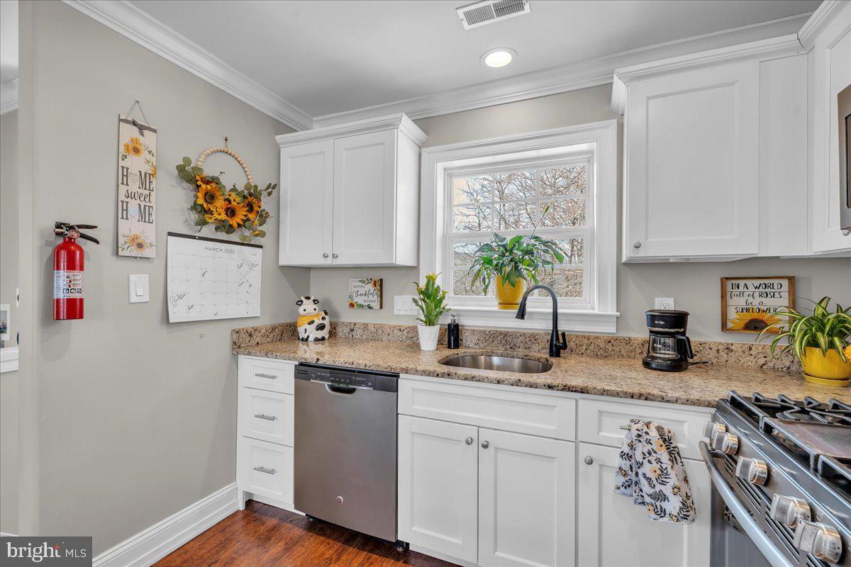 101 Center Avenue Mount Ephraim, NJ 08059 - Photo 27 of 42 a kitchen with stainless steel appliances granite countertop a stove a sink a refrigerator and a window