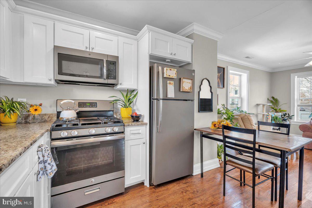 101 Center Avenue Mount Ephraim, NJ 08059 - Photo 28 of 42 a kitchen with stainless steel appliances a stove a microwave and a refrigerator