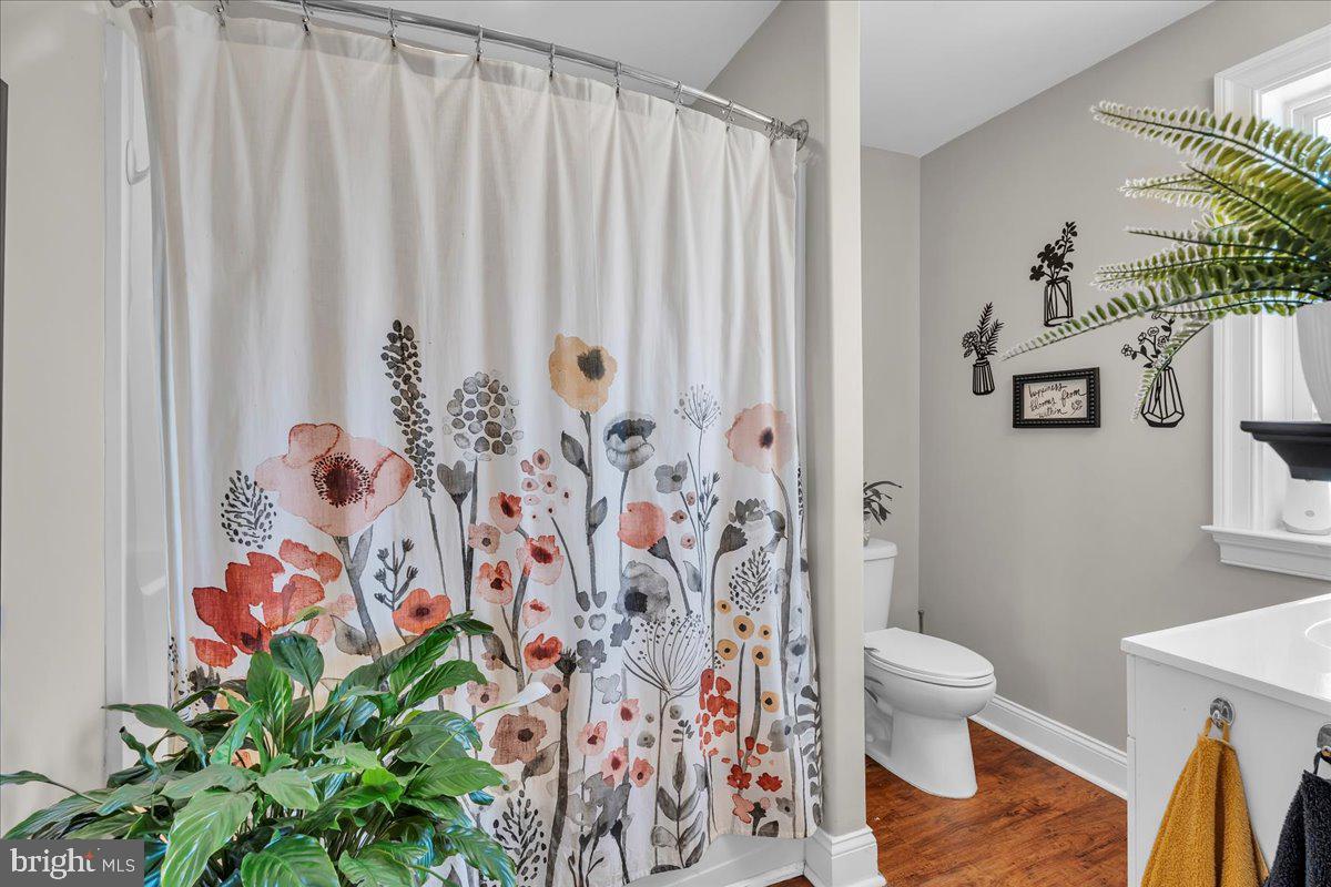 101 Center Avenue Mount Ephraim, NJ 08059 - Photo 32 of 42 a white toilet sitting next to a shower curtain