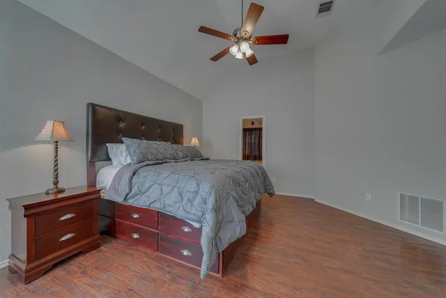 a bedroom with a bed and a chandelier