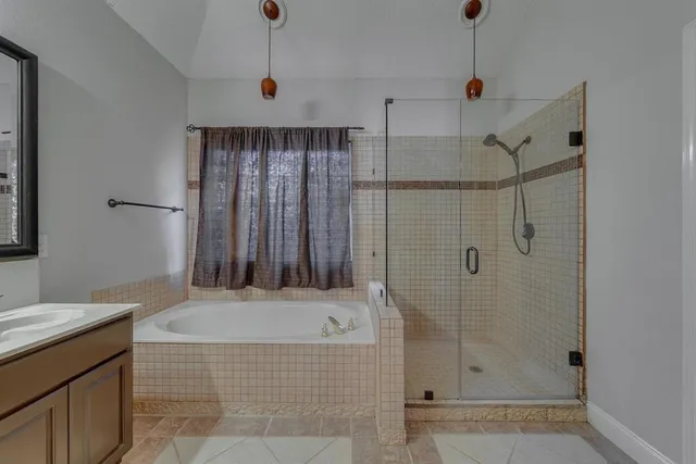 a bathroom with a bathtub and shower