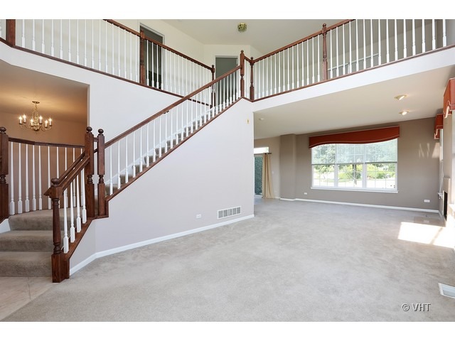 897 Havenshire Road, Unit 897 Naperville, IL 60565 - Photo 2 of 14 a view of staircase with white walls and a window