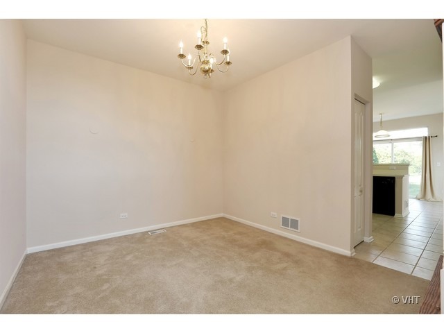 897 Havenshire Road, Unit 897 Naperville, IL 60565 - Photo 7 of 14 a view of a room with chandelier fan