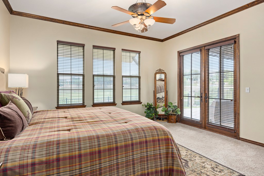 3801-16 Club House Road Kerrville, TX 78028 - Photo 12 of 22 a bedroom with a large bed and a large window
