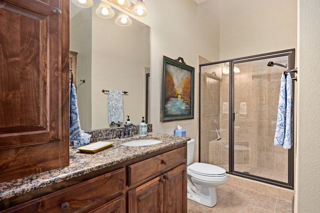 3801-16 Club House Road Kerrville, TX 78028 - Photo 14 of 22 a bathroom with a double vanity sink toilet and shower