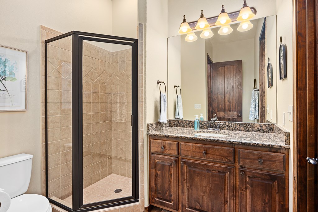 3801-16 Club House Road Kerrville, TX 78028 - Photo 16 of 22 a bathroom with a granite countertop sink and a mirror