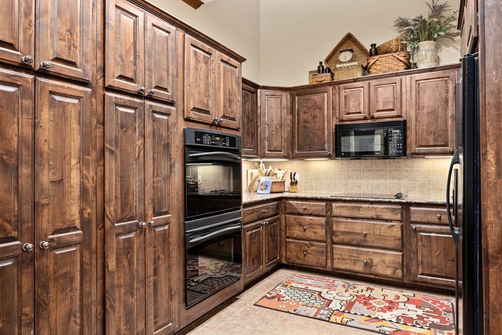 3801-16 Club House Road Kerrville, TX 78028 - Photo 5 of 22 a kitchen with stainless steel appliances a refrigerator and cabinets