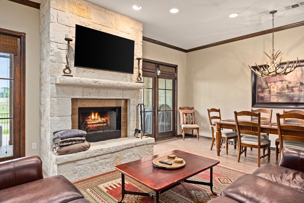 3801-16 Club House Road Kerrville, TX 78028 - Photo 7 of 22 a living room with furniture a flat screen tv and a fireplace