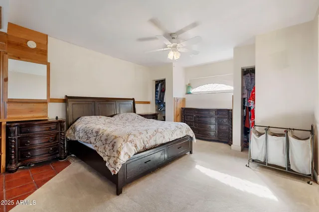 a spacious bedroom with a bed and a chandelier