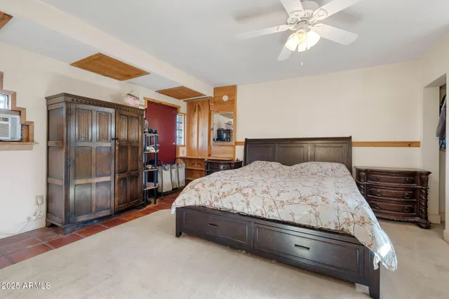 a spacious bedroom with a bed and a fireplace