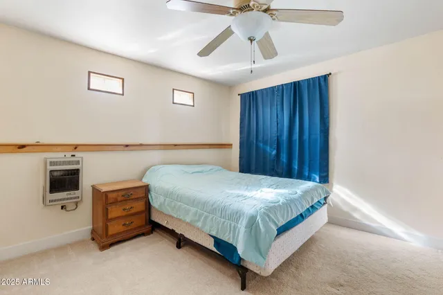 a bedroom with a bed and a television