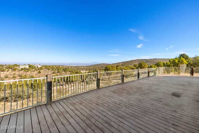 a view of a forest with mountains in the background