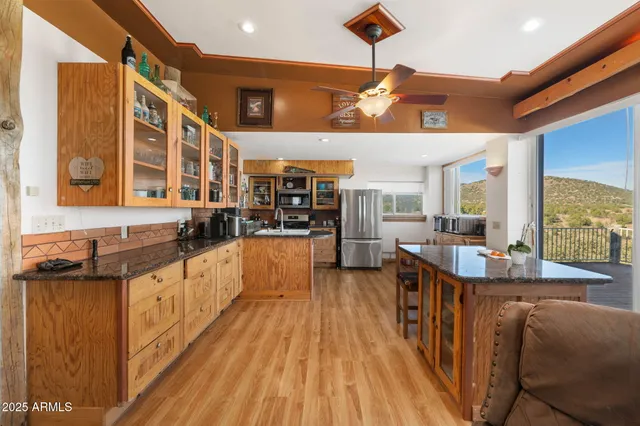 a large kitchen with lots of counter space and stainless steel appliances