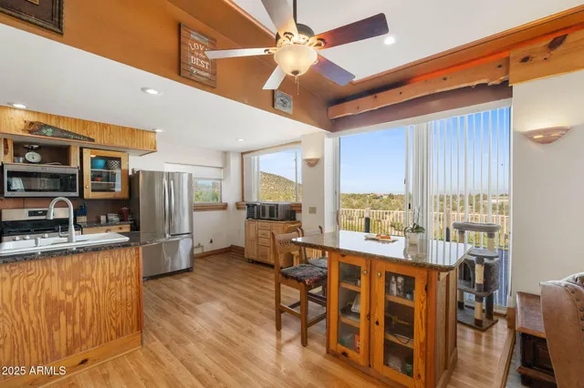 a kitchen with stainless steel appliances granite countertop a stove and cabinets