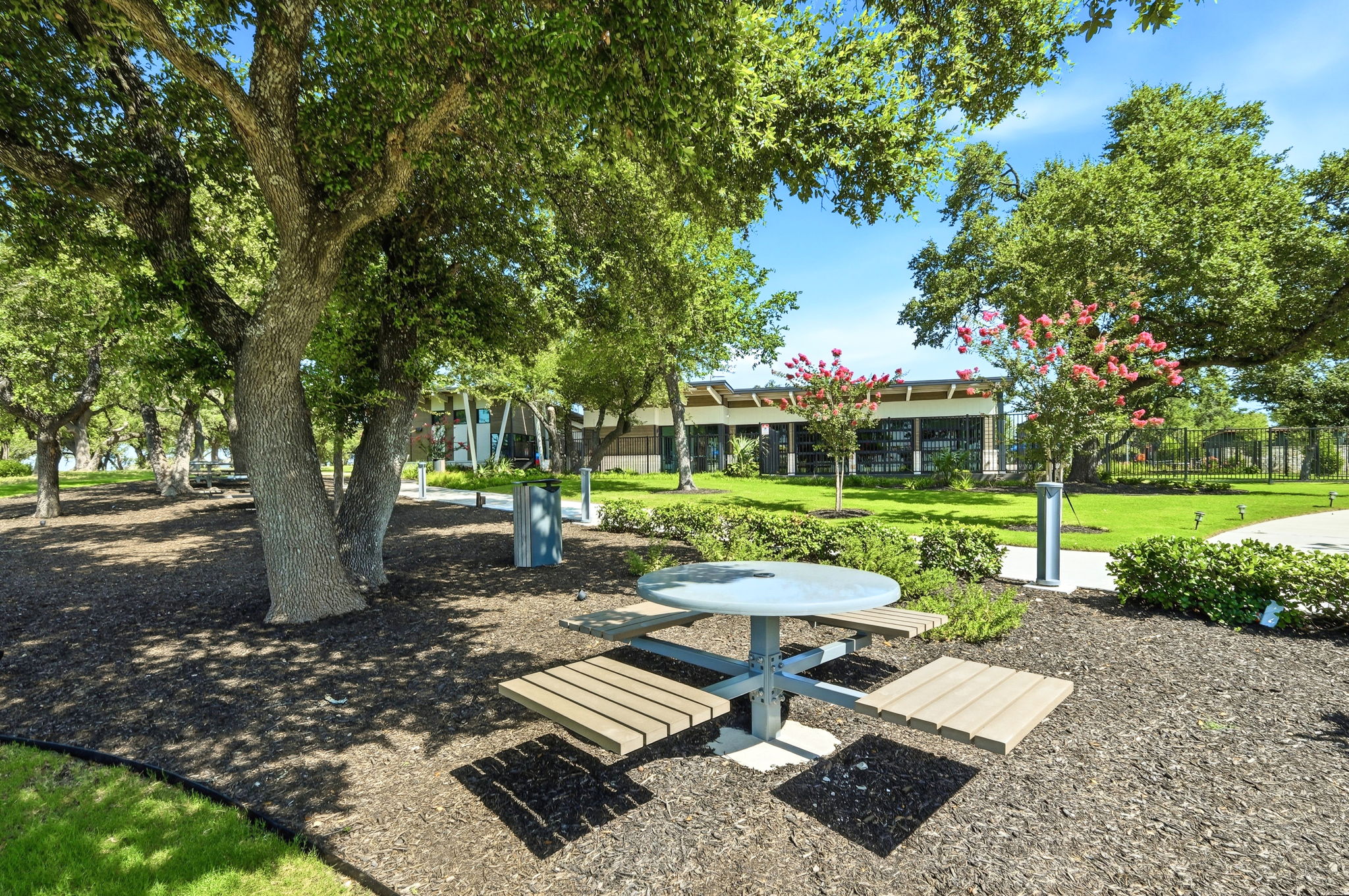 220 Lucky Texan Road Jarrell, TX 76537 - Photo 17 of 19 Enjoy outdoor dining amidst lush landscaping with ample space for relaxation.