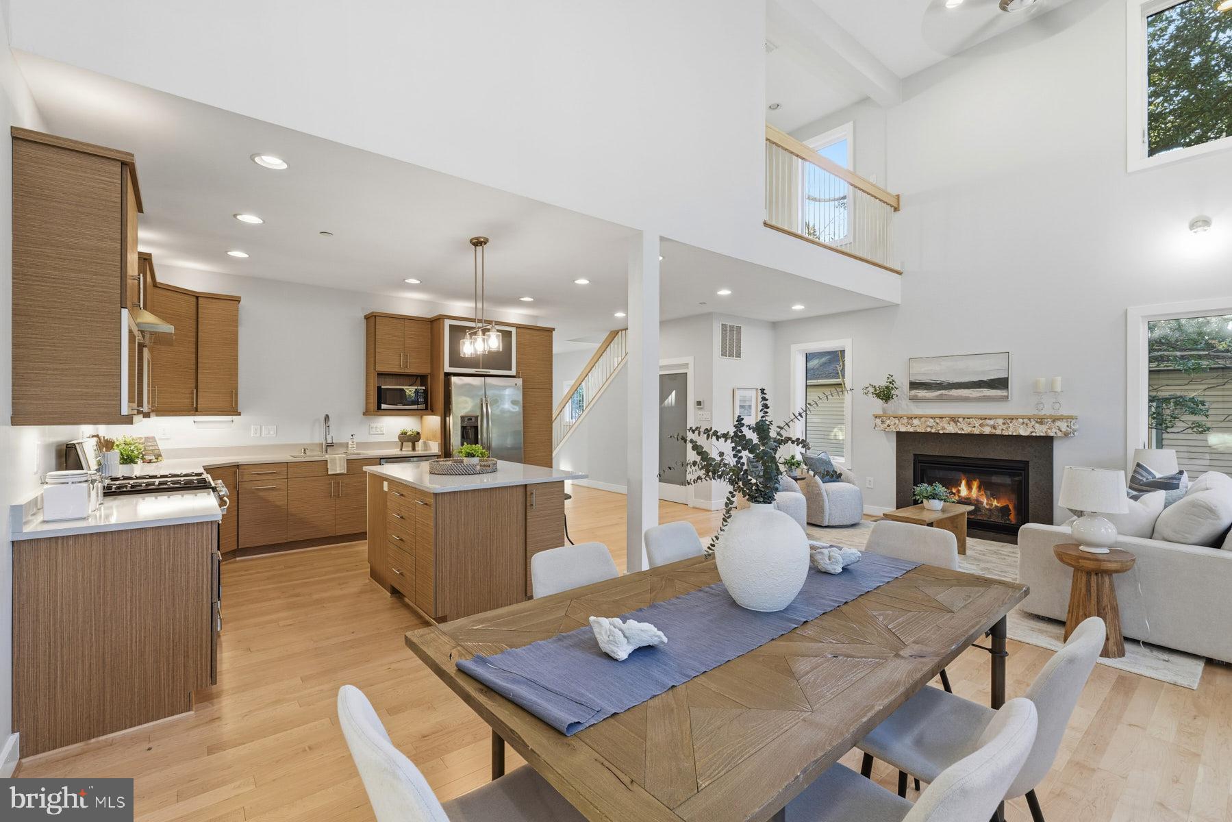 34 Johnson Road Pasadena, MD 21122 - Photo 13 of 45 a kitchen with a dining table wooden floor and a living room