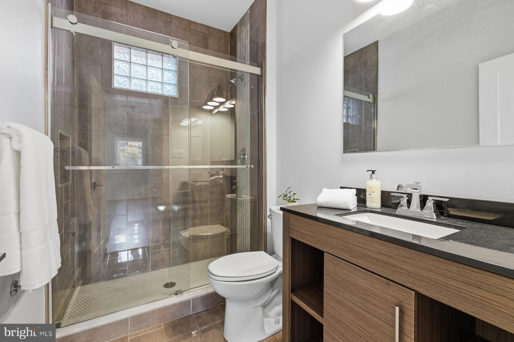 34 Johnson Road Pasadena, MD 21122 - Photo 18 of 45 a bathroom with a granite countertop toilet sink and mirror
