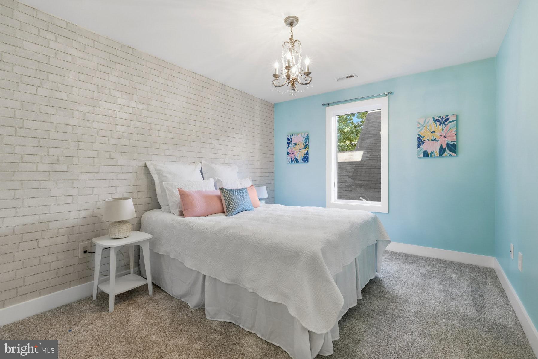 34 Johnson Road Pasadena, MD 21122 - Photo 30 of 45 a bedroom with a bed and a chandelier