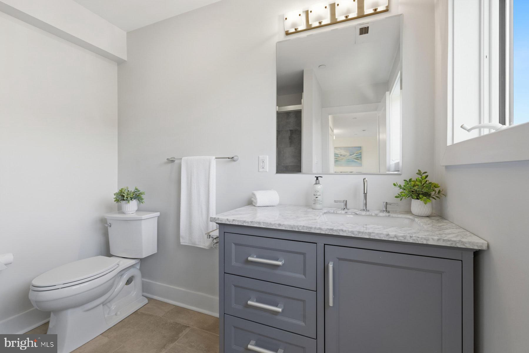 34 Johnson Road Pasadena, MD 21122 - Photo 35 of 45 a bathroom with a granite countertop toilet sink and mirror