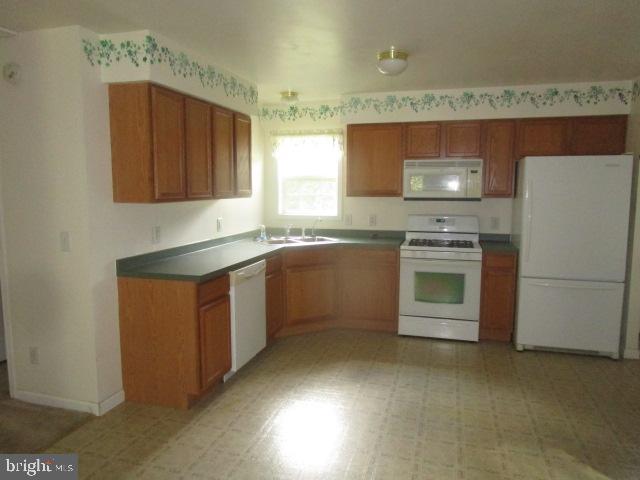 551 Post Road Rising Sun, MD 21911 - Photo 4 of 6 a kitchen with a stove sink and cabinets