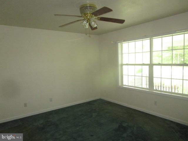551 Post Road Rising Sun, MD 21911 - Photo 5 of 6 an empty room with a window and a fan