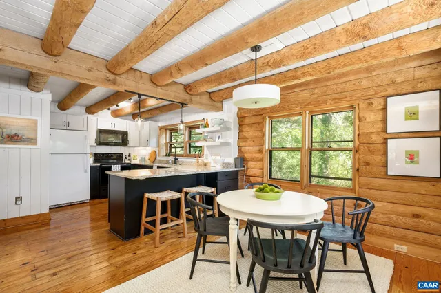 a dining room with furniture a chandelier and wooden floor