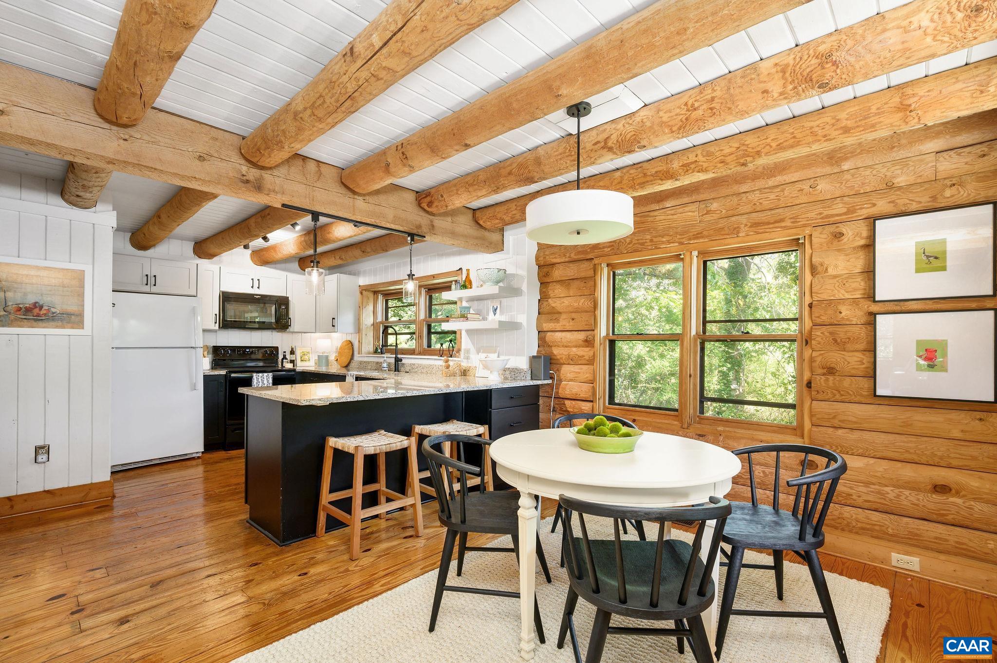 3946 Rock Branch Road North Garden, VA 22959 - Photo 13 of 36 a dining room with furniture a chandelier and wooden floor
