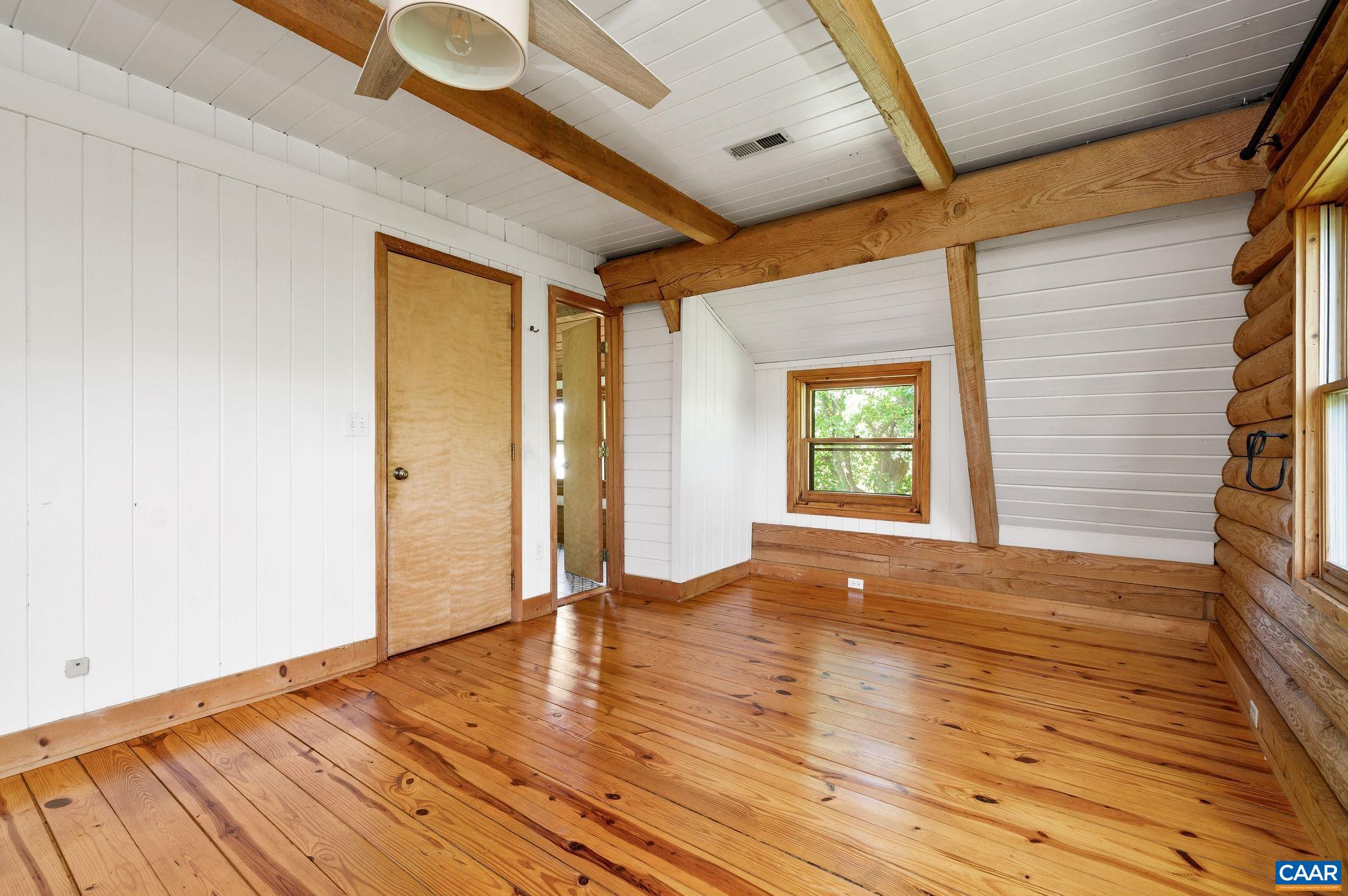 3946 Rock Branch Road North Garden, VA 22959 - Photo 21 of 36 a view of an empty room with wooden floor and a window