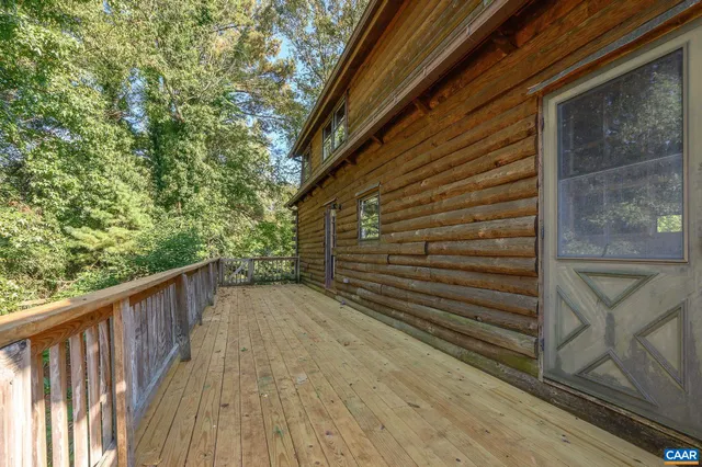 a view of balcony with wooden floor and fence