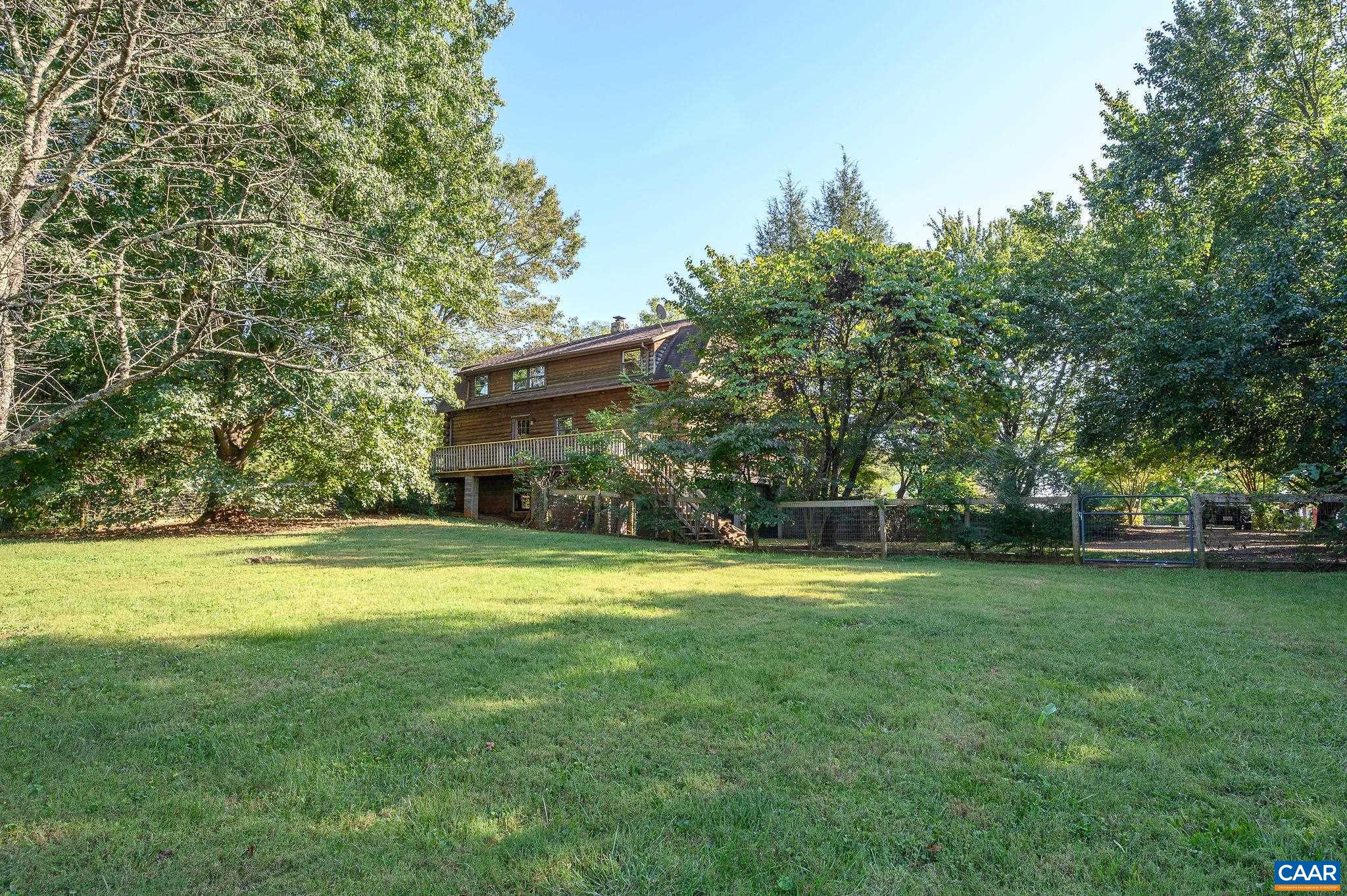 3946 Rock Branch Road North Garden, VA 22959 - Photo 35 of 36 a view of a house with a big yard and large trees