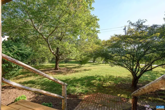 a view of a yard with wooden fence
